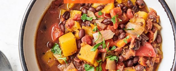 Hearty bowl of The Fresh 20 Instant Pot Crock-Pot vegetarian chipotle chili with lime wedges for entertaining from above