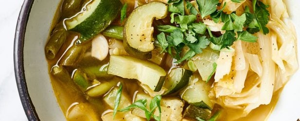 Beautiful bowl full of detox Instant Pot hearty soup garnished with herbs