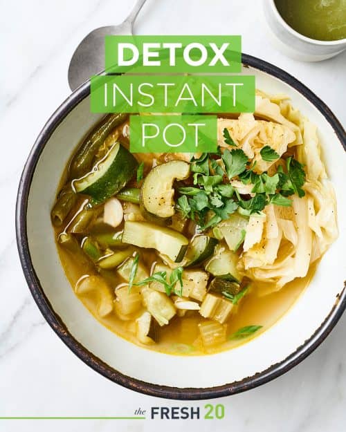 Beautiful bowl full of detox Instant Pot hearty soup with a spoon on a white marble surface