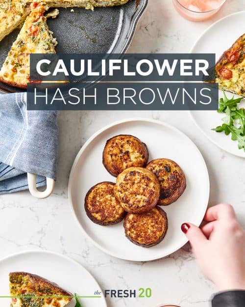 Woman placing cermic plate full of browned cauliflower hashbrowns on a white marble surface by fritata skillet