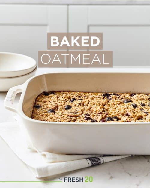 Staub baking pan filled with homemade baked oatmeal on a white marble surface and linen napkin