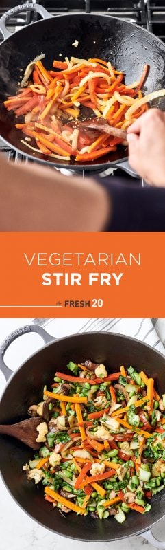 Person cooking with Le Creuset wok filled with vibrant 8 vegetable stir-fry on a cooktop and white marble kitchen