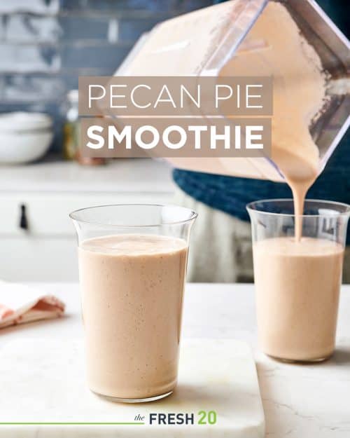 Man pouring pecan pie holiday smoothie into 2 glasses in a white marble kitchen
