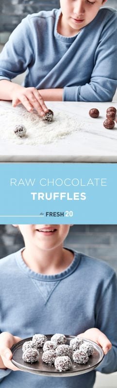 Young boy rolling heart healthy raw chocolate truffles in a pile of shredded coconut in a white marble kitchen