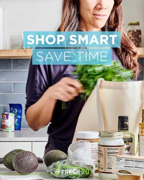 Woman unpacking fresh groceries in her modern kitchen