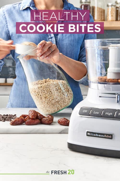 Woman scooping out oatmeal to make healthy cookies with a food processor in a modern kitchen