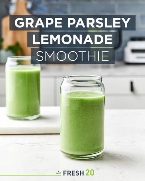 Two tall glasses of healthy green grape parsley lemonade smoothie in a beautiful white marble kitchen