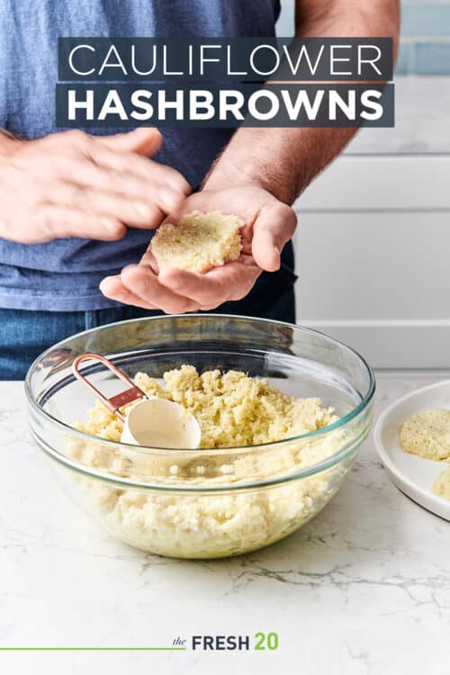 Man shaping cauliflower hashbrowns and placing them onto a ceramic plate in a white marble kitchen