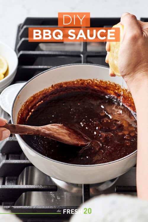 Person making homemade DIY BBQ sauce & squeezing lemon into a pot on a cooktop stove