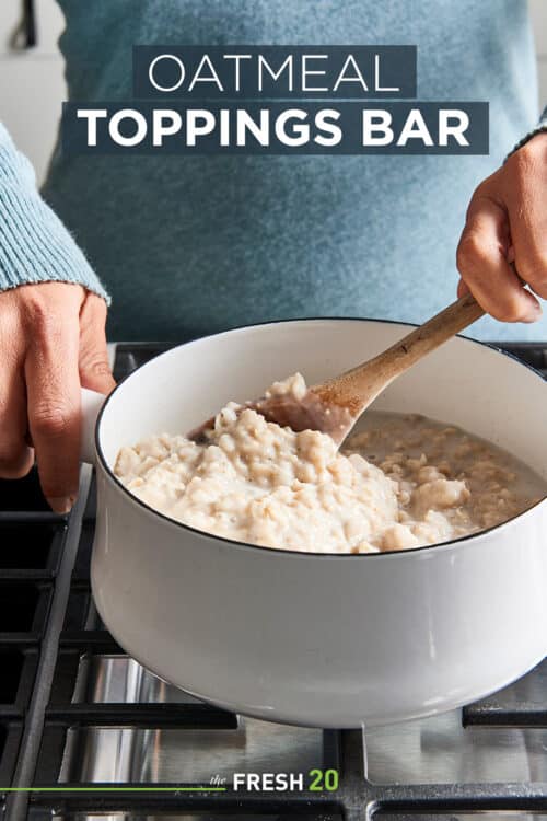 Woman stirring a fresh batch of oatmeal in a white pot on a black metal cooktop