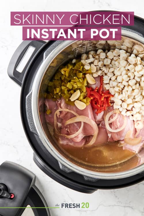 Easy Instant Pot skinny chicken full of healthy meat and vegetables on a white marble surface